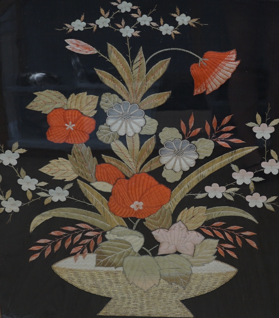 A 1900 to 1920’s Japanese silk embroidery of birds in flight and flowers on a grey background, 131cm high, 52cm wide, together with a Japanese silk and metallic thread still life embroidery on black background, with couc